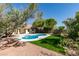 Backyard view features a lush lawn, mature landscaping and private pool at 6126 Bedrock Ct, North Las Vegas, NV 89031