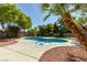 Backyard pool view features a unique kidney shape, relaxing spa and lush landscaping at 6126 Bedrock Ct, North Las Vegas, NV 89031