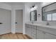 Bright bathroom featuring double sinks, modern vanity, and sleek fixtures at 6126 Bedrock Ct, North Las Vegas, NV 89031
