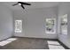 Spacious bedroom featuring natural light, vaulted ceilings, and plush carpeting at 6126 Bedrock Ct, North Las Vegas, NV 89031