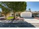 Charming single-story home with a well-manicured lawn, mature trees, and a spacious driveway at 6126 Bedrock Ct, North Las Vegas, NV 89031