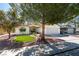 Attractive single-story home featuring a manicured lawn, mature trees, and a two-car garage at 6126 Bedrock Ct, North Las Vegas, NV 89031
