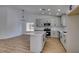 Bright kitchen with modern lighting, stainless appliances, island, and white countertops at 6126 Bedrock Ct, North Las Vegas, NV 89031