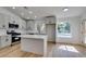 Bright kitchen with stainless appliances, island, and white countertops and pool view at 6126 Bedrock Ct, North Las Vegas, NV 89031