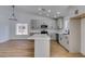 Bright kitchen with modern lighting, stainless appliances, island, and white countertops at 6126 Bedrock Ct, North Las Vegas, NV 89031