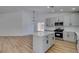 Bright kitchen with modern lighting, stainless appliances, island, and white countertops at 6126 Bedrock Ct, North Las Vegas, NV 89031