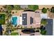 Aerial view of a home featuring a solar-paneled roof, refreshing swimming pool, and meticulously landscaped grounds at 6489 Crest Estates St, Las Vegas, NV 89131
