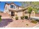 Inviting two-story home with stone accents, a three-car garage, and a well-manicured front yard at 6489 Crest Estates St, Las Vegas, NV 89131