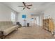 Large bonus room features wood-style flooring, a ceiling fan, a tan futon, and an entertainment center at 6489 Crest Estates St, Las Vegas, NV 89131