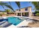 Fenced pool and attached hot tub create a backyard oasis surrounded by palm trees and gravel at 6489 Crest Estates St, Las Vegas, NV 89131