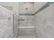 Beautifully tiled shower with built in seat, rain shower head, and handheld sprayer at 6489 Crest Estates St, Las Vegas, NV 89131