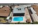 Aerial view of a backyard featuring a sparkling blue pool, a cozy patio, and shade trees at 6628 Celeste Ave, Las Vegas, NV 89107