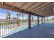 A covered balcony with an ornamental iron railing overlooks the sparkling pool below at 6628 Celeste Ave, Las Vegas, NV 89107