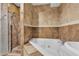 A bathroom with a soaking tub, a tiled surround, and updated fixtures at 6628 Celeste Ave, Las Vegas, NV 89107