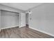 Bedroom with wood floors, closet with shelving, and access to the hallway at 6628 Celeste Ave, Las Vegas, NV 89107