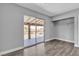 Bedroom with wood floors, closet with shelving, and sliding glass door leading to a balcony at 6628 Celeste Ave, Las Vegas, NV 89107