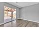 Neutral bedroom with wood floors and a sliding glass door out to the covered balcony at 6628 Celeste Ave, Las Vegas, NV 89107