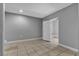 A bright bedroom with neutral walls, tiled floors, and closet space at 6628 Celeste Ave, Las Vegas, NV 89107