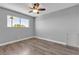 Bedroom features modern ceiling fan, hardwood floors and a bright window at 6628 Celeste Ave, Las Vegas, NV 89107