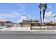 Two-story home featuring a driveway, two palm trees, a front yard, and secure fencing at 6628 Celeste Ave, Las Vegas, NV 89107