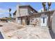 View of the rear exterior featuring outdoor kitchen, palm trees and rear access door at 6628 Celeste Ave, Las Vegas, NV 89107