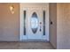 Elegant white front door featuring glass paneling with decorative design and an outdoor light fixture at 6628 Celeste Ave, Las Vegas, NV 89107