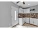 A quaint kitchen features white cabinets, a tiled backsplash, and stainless steel appliances at 6628 Celeste Ave, Las Vegas, NV 89107