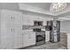 Modern kitchen featuring stainless steel appliances, white cabinets, and marble flooring at 6628 Celeste Ave, Las Vegas, NV 89107