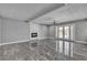Open concept living room features a fireplace, double doors to outside, and tile flooring at 6628 Celeste Ave, Las Vegas, NV 89107