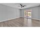 Light filled main bedroom, offering hardwood flooring, and sliding glass doors to the deck at 6628 Celeste Ave, Las Vegas, NV 89107