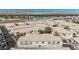 Aerial view of beige condos with mountain views in the distance, offering a tranquil desert community at 6808 Indian Chief Dr # 204, Las Vegas, NV 89130