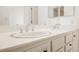 Close-up of the bathroom's double sink vanity with white countertop and mosaic detailing at 6808 Indian Chief Dr # 204, Las Vegas, NV 89130