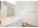 Bright bathroom featuring a sleek vanity with white cabinets and countertops, complemented by a large mirror and neutral tile flooring at 6808 Indian Chief Dr # 204, Las Vegas, NV 89130