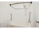 Clean, white bathtub and shower combination with safety bars and tile accents at 6808 Indian Chief Dr # 204, Las Vegas, NV 89130
