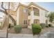 Inviting two-story condo with a private balcony, attractive landscaping, and staircase for easy access at 6808 Indian Chief Dr # 204, Las Vegas, NV 89130