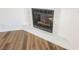 Close-up of fireplace with white trim and logs, complemented by wood-look flooring at 6808 Indian Chief Dr # 204, Las Vegas, NV 89130