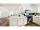 Open kitchen features white cabinets, stainless steel appliances and convenient access to the living space at 6808 Indian Chief Dr # 204, Las Vegas, NV 89130