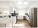 Bright kitchen featuring stainless steel appliances, a window, and white cabinets at 6808 Indian Chief Dr # 204, Las Vegas, NV 89130