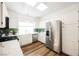 Bright kitchen features white cabinets, stainless steel appliances, wood floors and a skylight for natural light at 6808 Indian Chief Dr # 204, Las Vegas, NV 89130