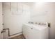 Laundry room with white washer and dryer, wire shelves, and neutral floor tiles at 6808 Indian Chief Dr # 204, Las Vegas, NV 89130