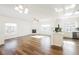 Open-concept living room with wood floors, a fireplace, and seamless flow to the bright, modern kitchen at 6808 Indian Chief Dr # 204, Las Vegas, NV 89130