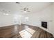 Bright living room showcasing wood-look flooring and a corner fireplace, creating a warm and inviting space at 6808 Indian Chief Dr # 204, Las Vegas, NV 89130