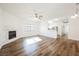 Bright living room featuring a fireplace, wood floors, and an open layout to the kitchen at 6808 Indian Chief Dr # 204, Las Vegas, NV 89130