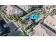 Overhead shot displaying the complex's pool with lounge area, palm trees, and adjacent parking at 6808 Indian Chief Dr # 204, Las Vegas, NV 89130
