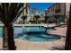 A pool area with palm trees and lounge chairs offers a refreshing outdoor retreat at 6808 Indian Chief Dr # 204, Las Vegas, NV 89130