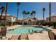 Community pool surrounded by palm trees and lounge chairs for relaxation on a sunny day at 6808 Indian Chief Dr # 204, Las Vegas, NV 89130