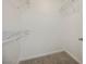 Empty walk-in closet features neutral carpet and shelving for optimal storage at 6808 Indian Chief Dr # 204, Las Vegas, NV 89130