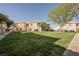 Green lawn area in front of two-story condos, offering community green space and street parking at 6808 Indian Chief Dr # 204, Las Vegas, NV 89130