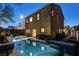 The backyard of this two-story home features a beautiful pool, patio, and well-maintained landscaping at 6897 Linda Creek Ct, Las Vegas, NV 89178