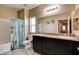 Well-lit bathroom featuring granite counters, double sinks, and a shower and tub combo at 6897 Linda Creek Ct, Las Vegas, NV 89178
